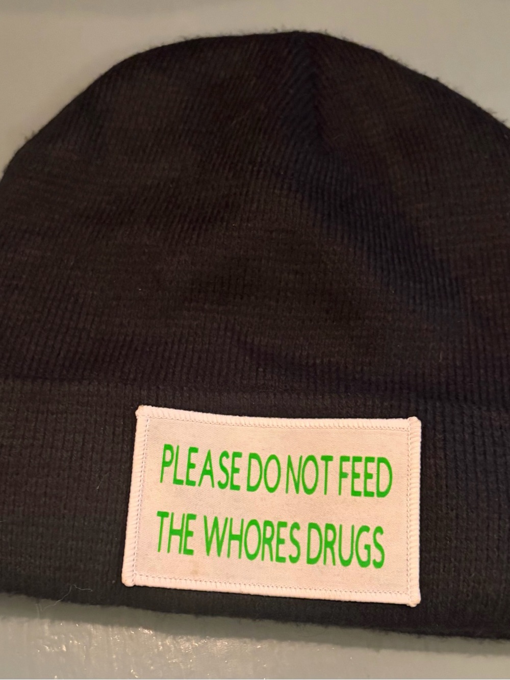 Black Knit Hat with Light Pink Slogan Patch